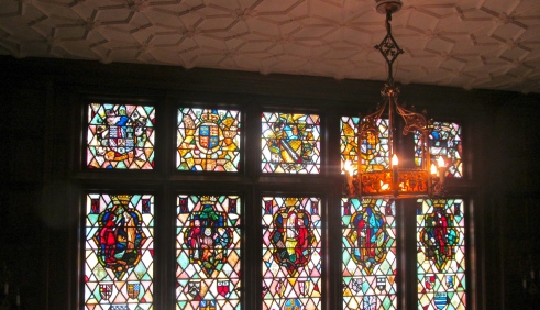 Stained glass windows depicting scenes from five Shakespearean plays.